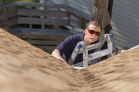a man inspecting a roof